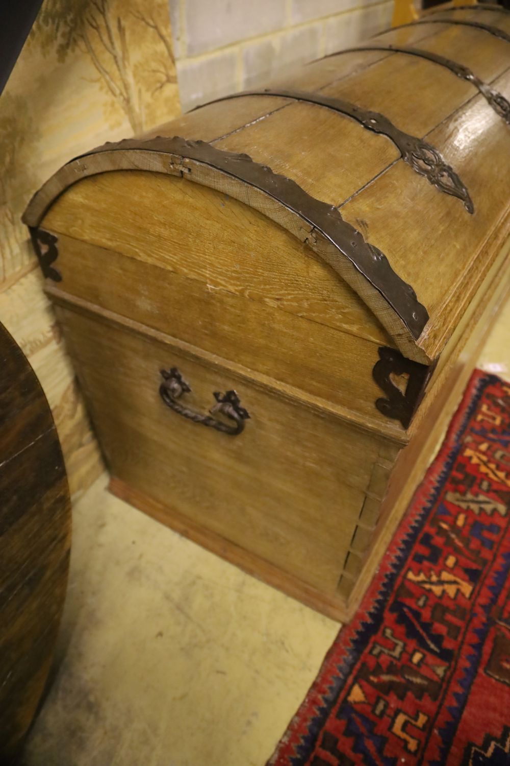 A 19th century pine dome top iron-bound travelling trunk/blanket chest on bun beet, width 128cm, depth 61cm, height 77cm